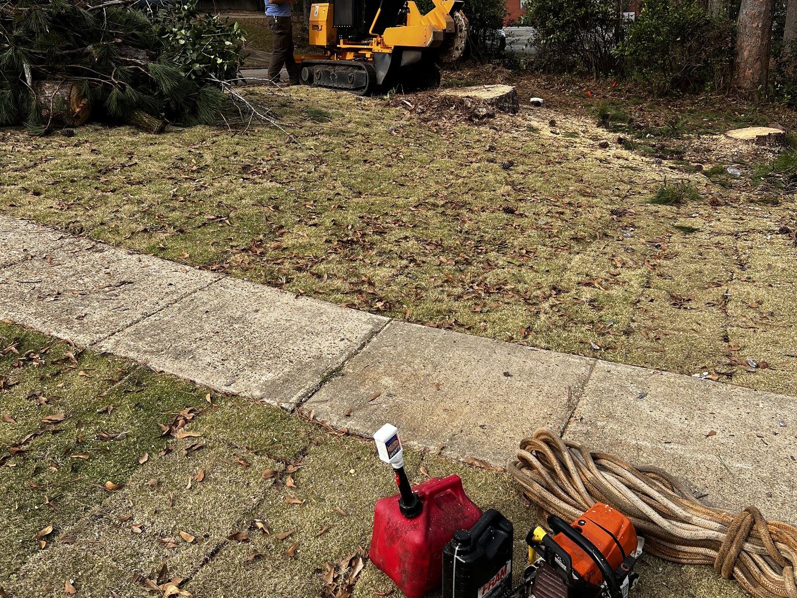 A cleared residential lot with All About Trees machinery and gear on site